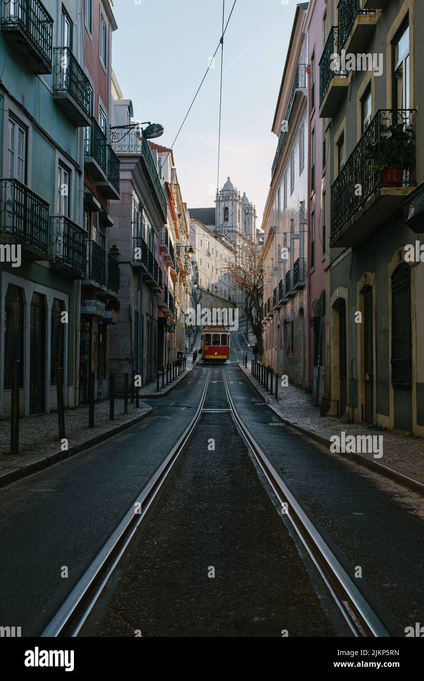 A vertical shot of a typical street with tram and its rails through ...
