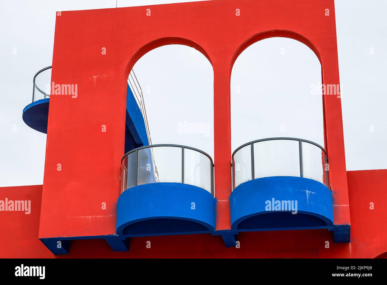 Close-up of modernist buildings in contrasting red and blue colors Stock Photo