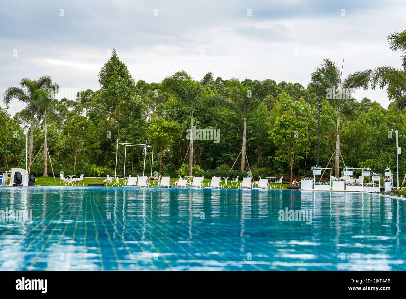 Infinity pool and lounge chairs in a luxury hotel Stock Photo - Alamy