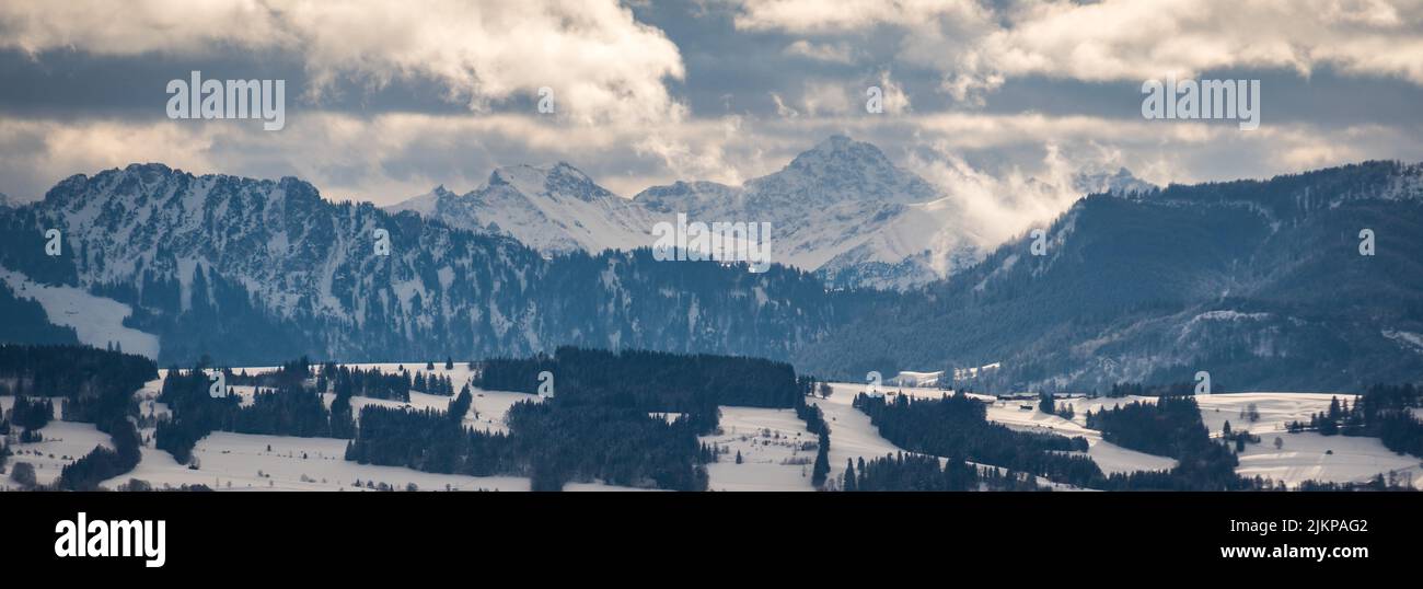A panoramic view of the snow-covered landscapes and valley in winter Stock Photo