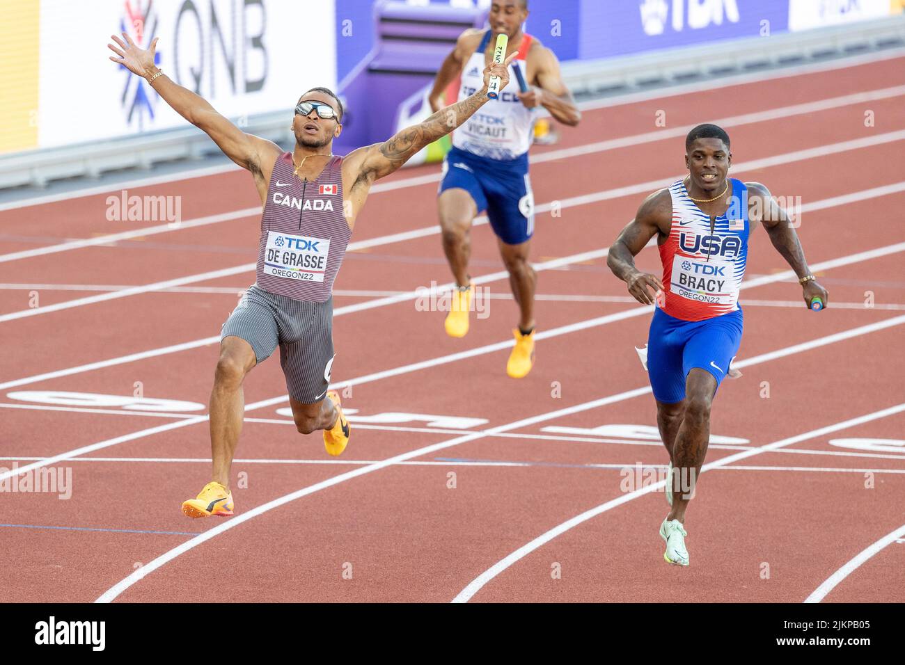 Andre De Grasse (CAN) raises his arms in victory after beating Marvin Bracy (USA) to the line in