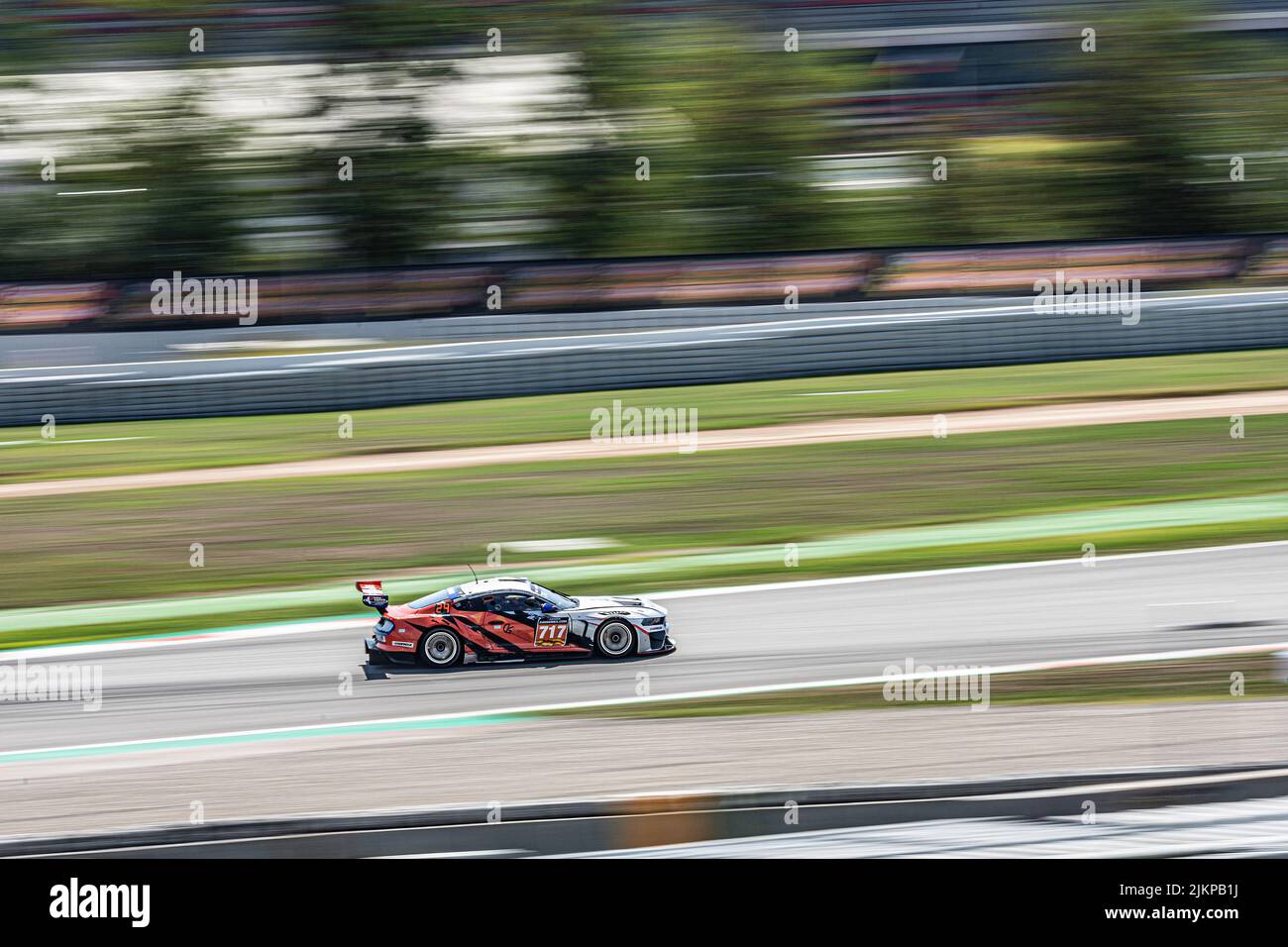 Fast race car in the track, silver and orange color. Marc II V8 Stock Photo