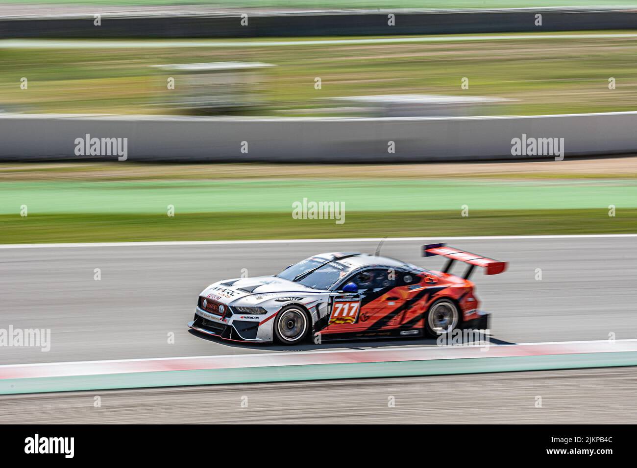 Fast race car in the track, silver and orange color. Marc II V8 Stock Photo