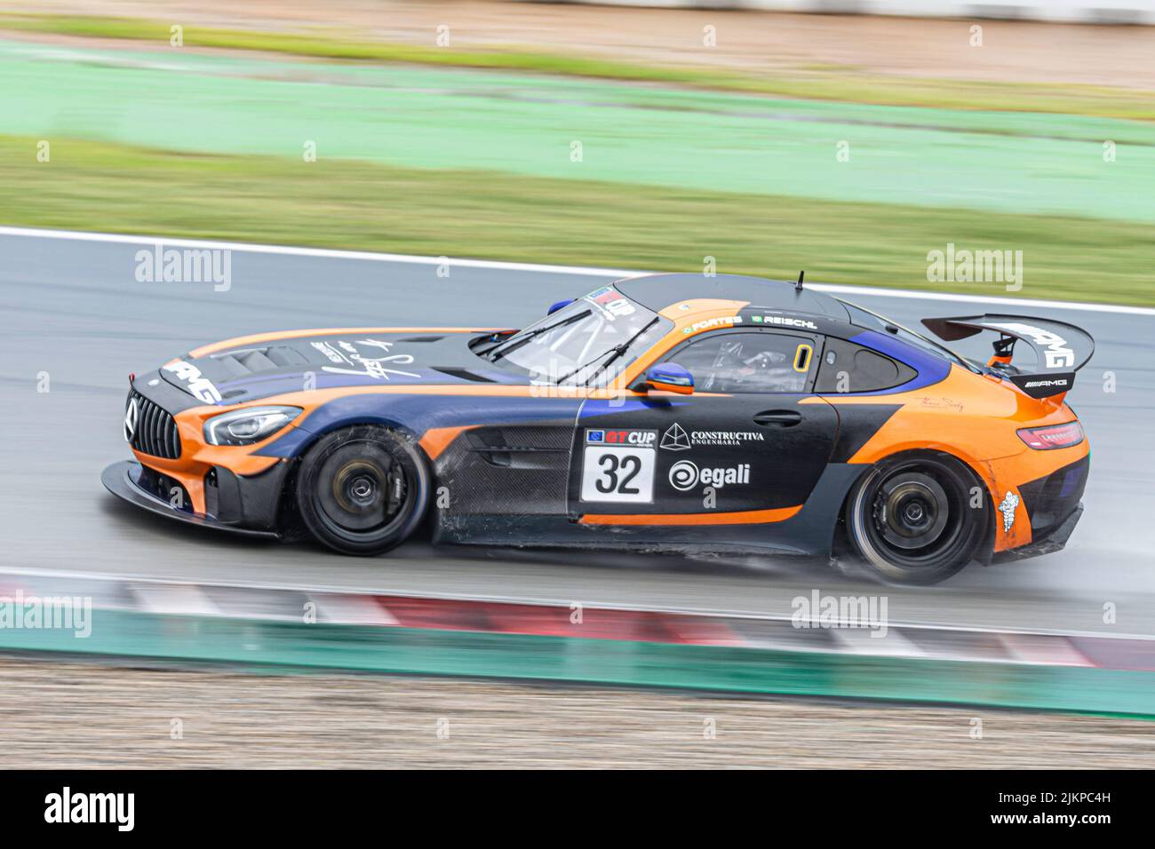 Fast race car in the wet track, Mercedes Benz AMG GT4 Stock Photo