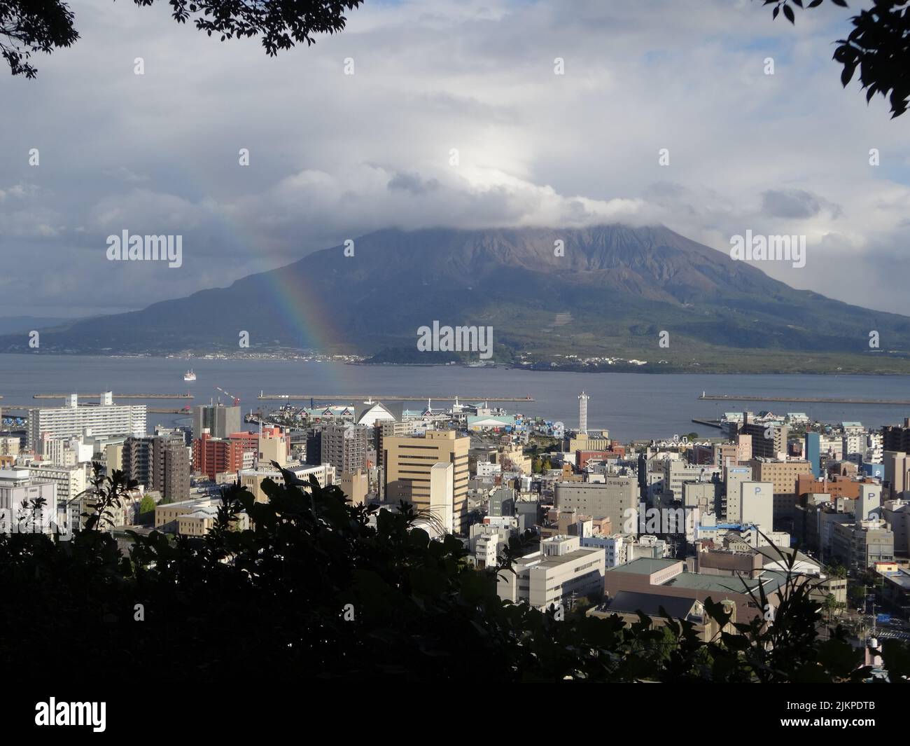 Sakurajima volcano in clouds with rainbow in Kagoshima Japan from  a viewpoint Stock Photo