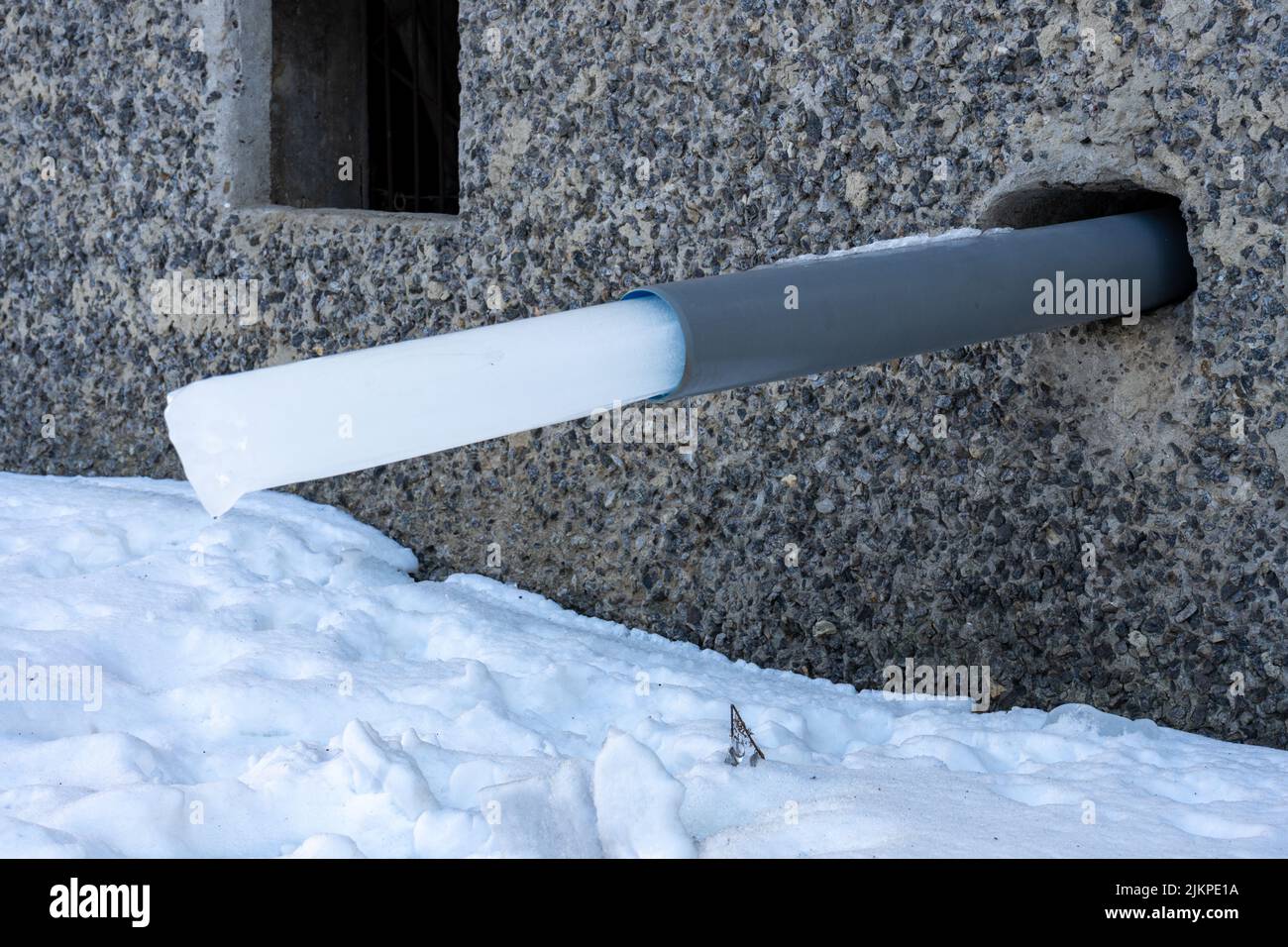 A water pipe in a house with a frozen piece of ice. rainwater harvesting Stock Photo