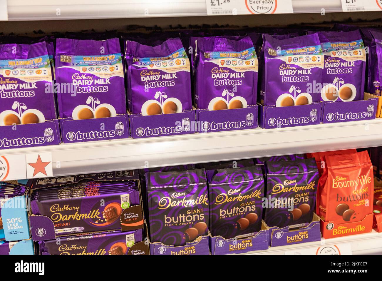 Cadbury Dairy Milk chocolate buttons in bags for sale in an English supermarket,UK,summer 2022 Stock Photo