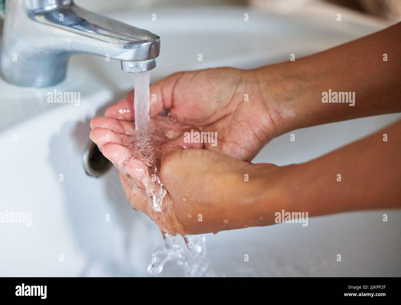 Water, the worlds first and foremost medicine. an unrecognizable male washing his hands in a hand basin at home. Stock Photo