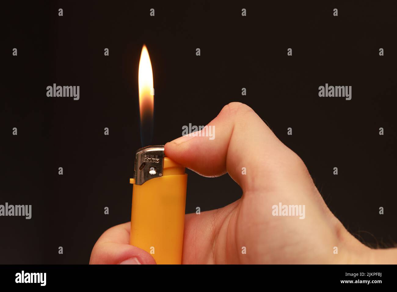 Hand holding lighter cigarette lighter hires