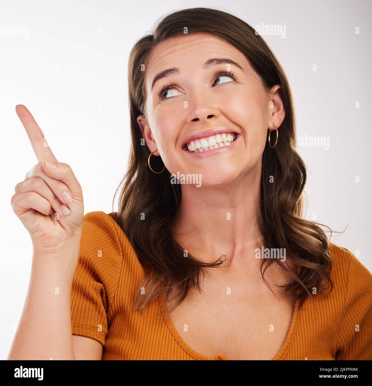 Cheerful young woman pointing hi-res stock photography and images - Alamy