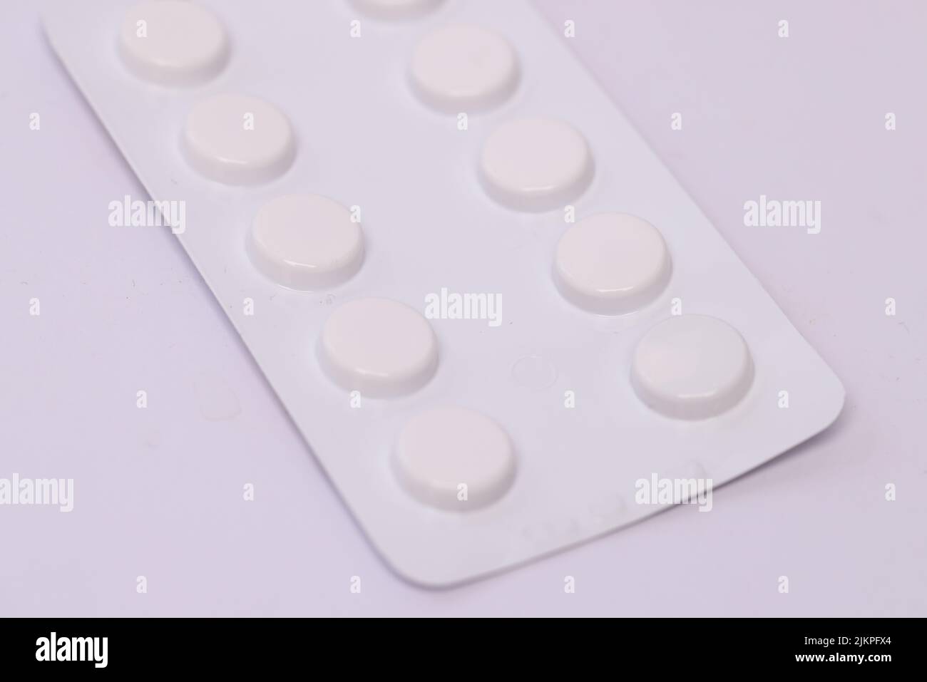 A closeup of pills in a blister pack isolated on white background. Stock Photo