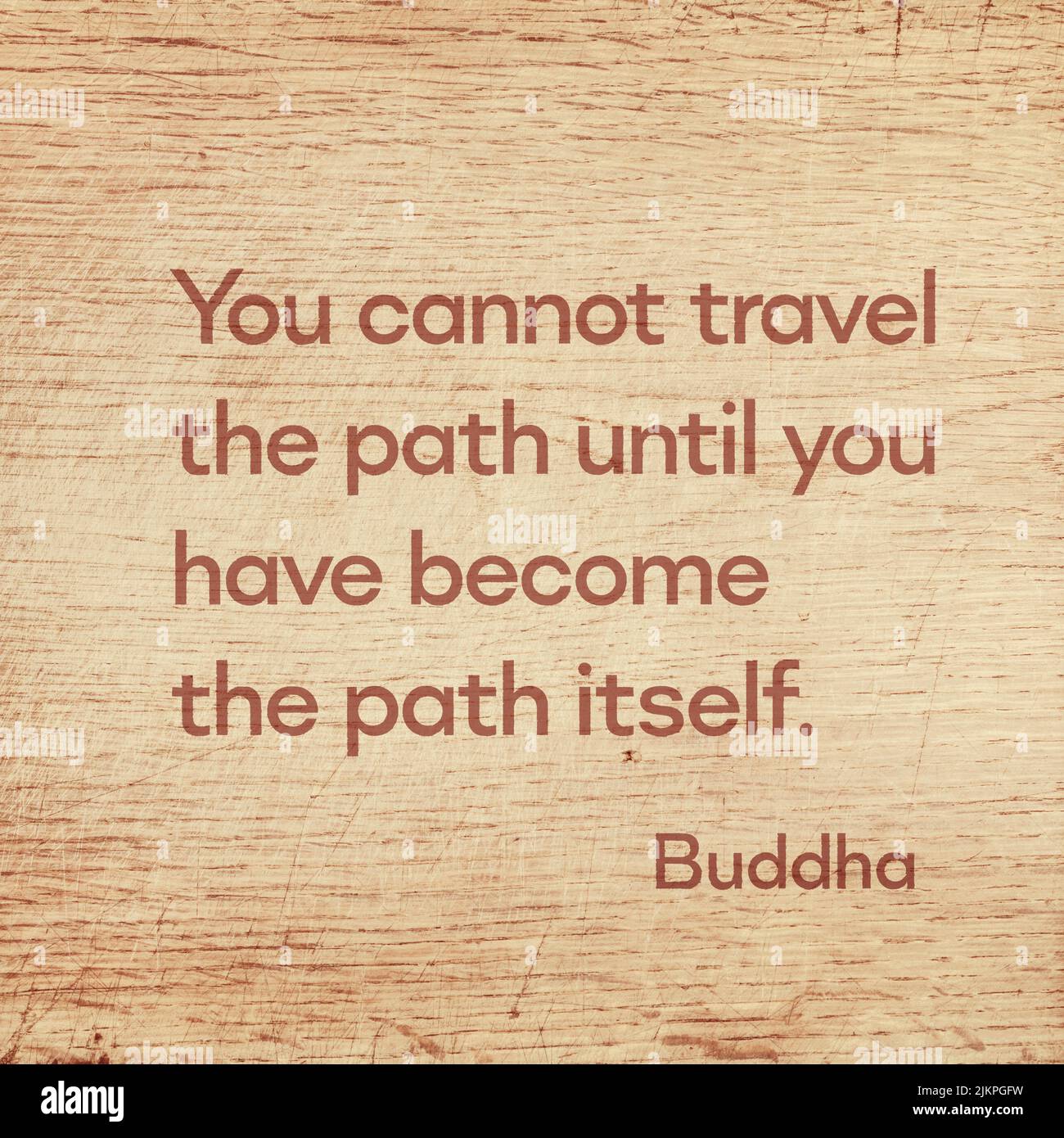 You cannot travel the path until you have become the path itself - famous quote of Gautama Buddha printed on grunge wooden board Stock Photo