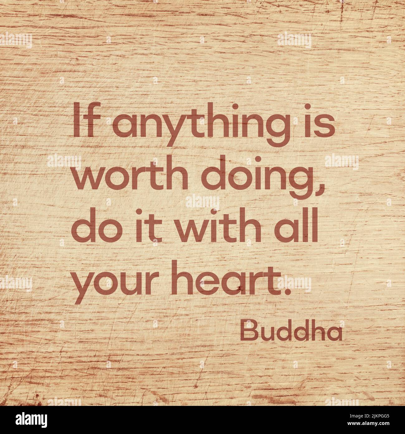 If anything is worth doing, do it with all your heart - famous quote of Gautama Buddha printed on grunge wooden board Stock Photo