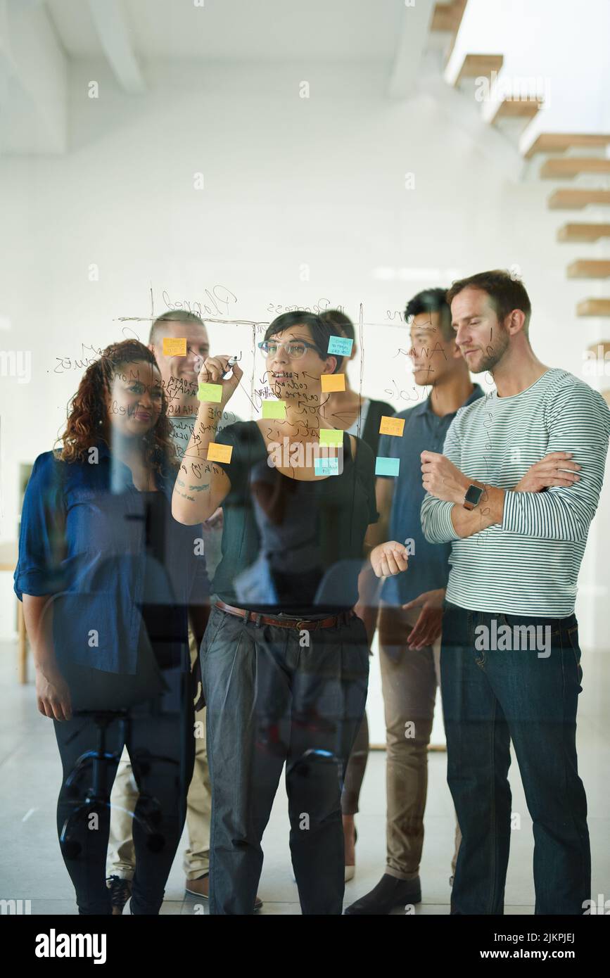 Diverse team of creative designers brainstorming and planning in an