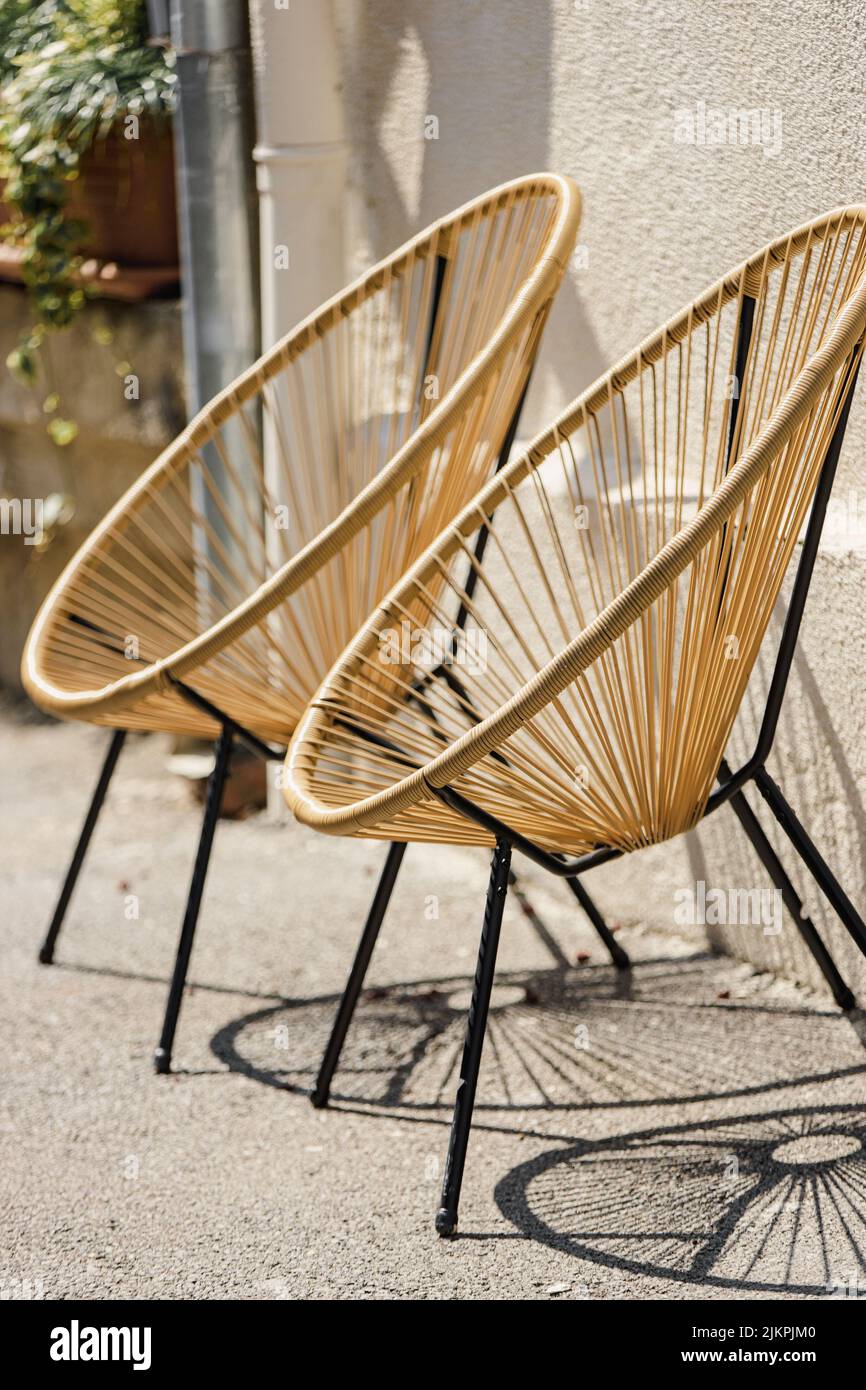 Cafe Furniture. Trendy Designer Chairs. Rattan Wicker Chair. Wicker Armchairs Stand Outside. Modern Furniture At Street. Fashion Designer Armchairs Stock Photo