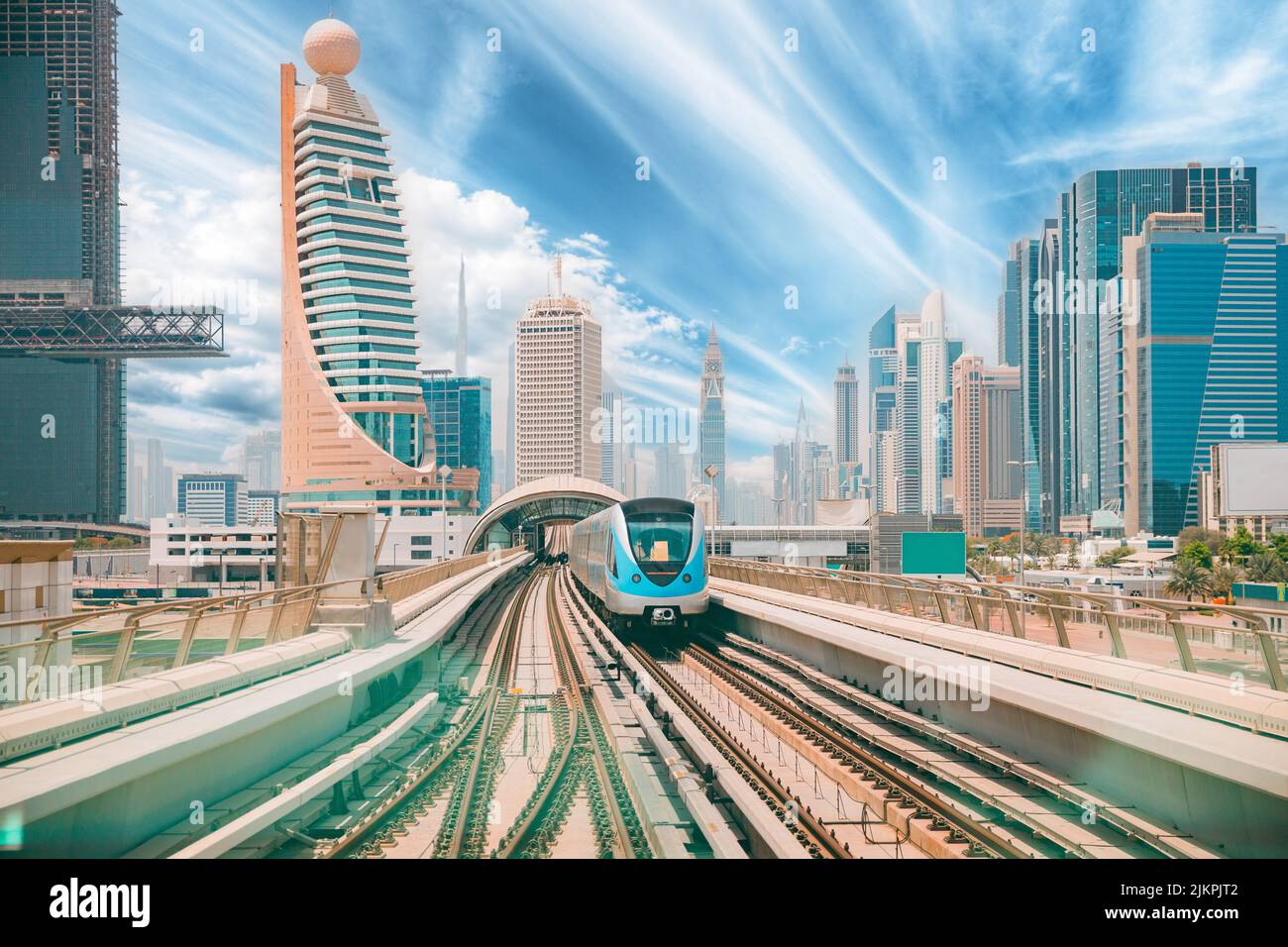 Monorail Subway train rides among glass skyscrapers in Dubai. Traffic on street in Dubai. Cityscape skyline. Urban background Stock Photo