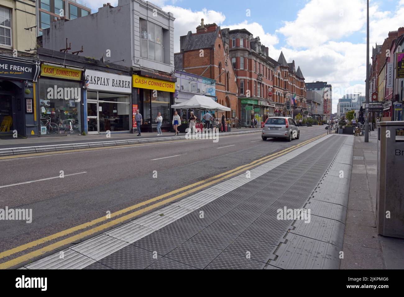 People dining at a cafe on the streets of the Victorian quarter of Cork city, Ireland, July 2022
