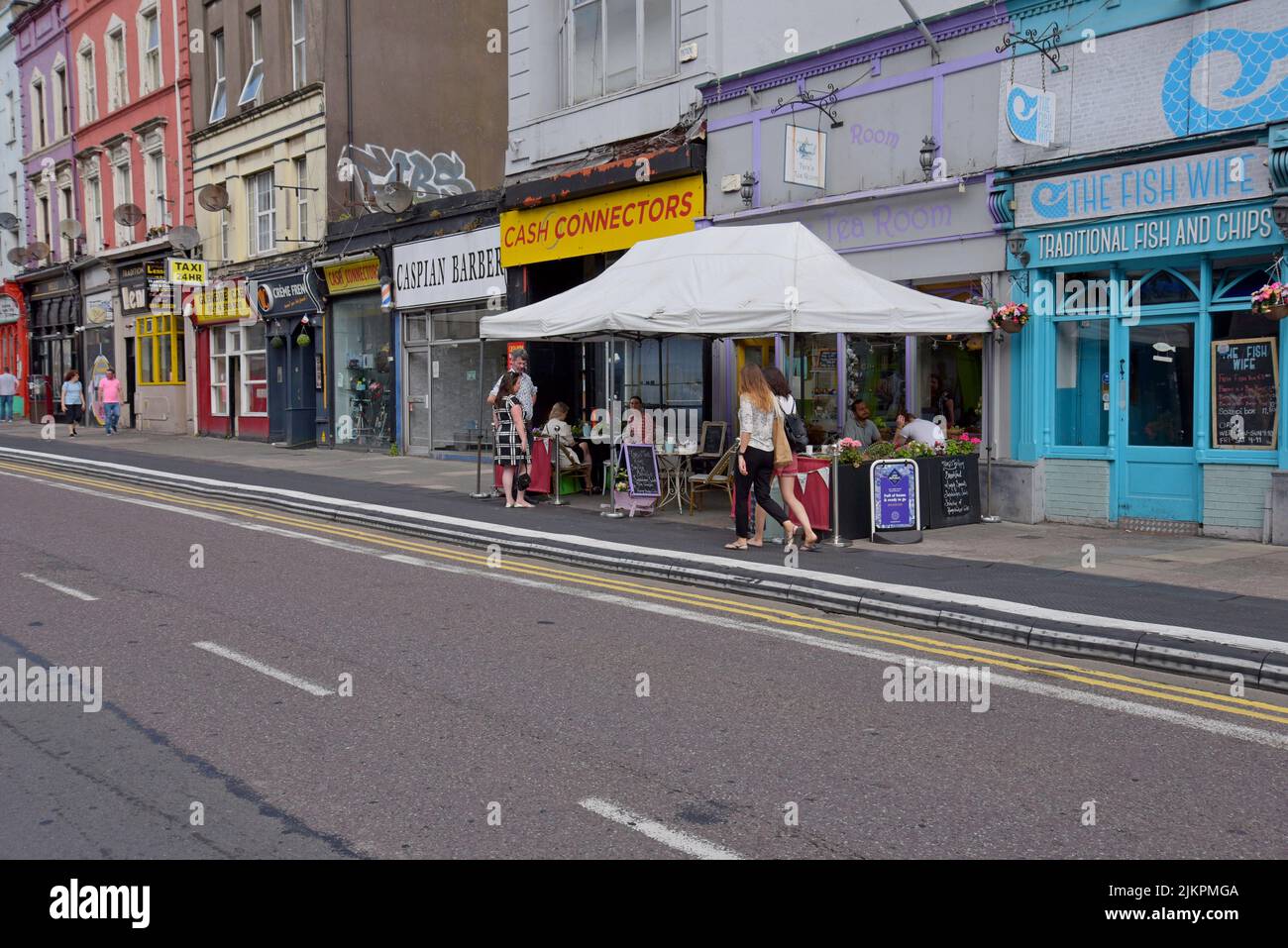 People dining at a cafe on the streets of the Victorian quarter of Cork city, Ireland, July 2022 Stock Photo
