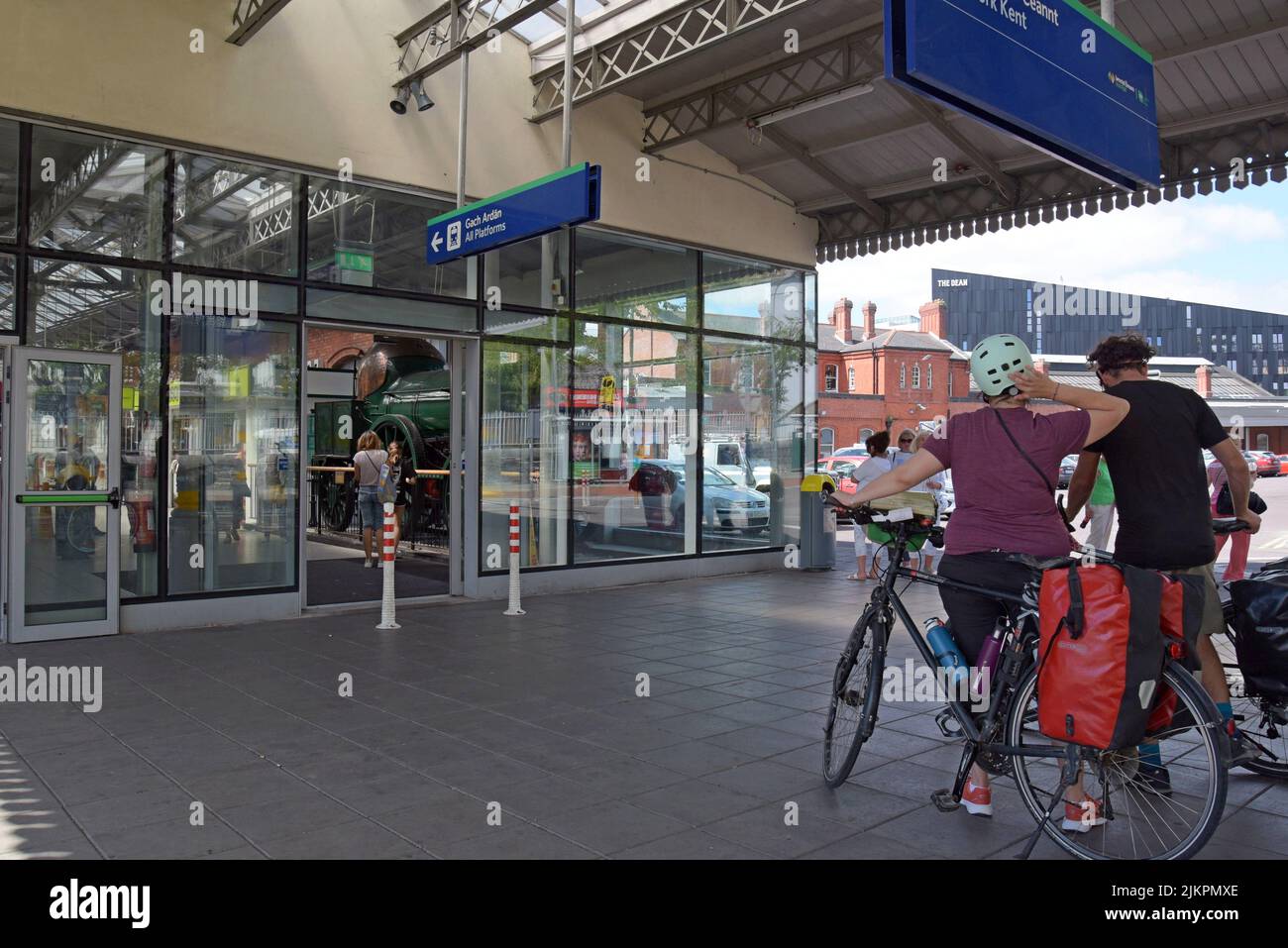 Cyclists arriving  at the entrance to Cork Kent railway Station, Cork city, Ireland, July 2022 Stock Photo