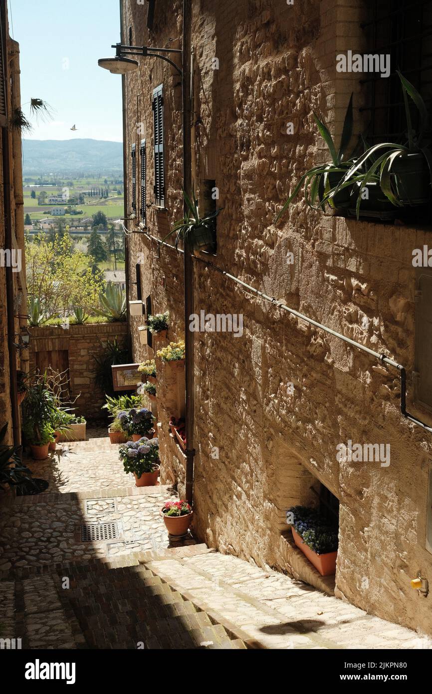 A vertical shot of the narrow street in Assisi. Italy. Stock Photo
