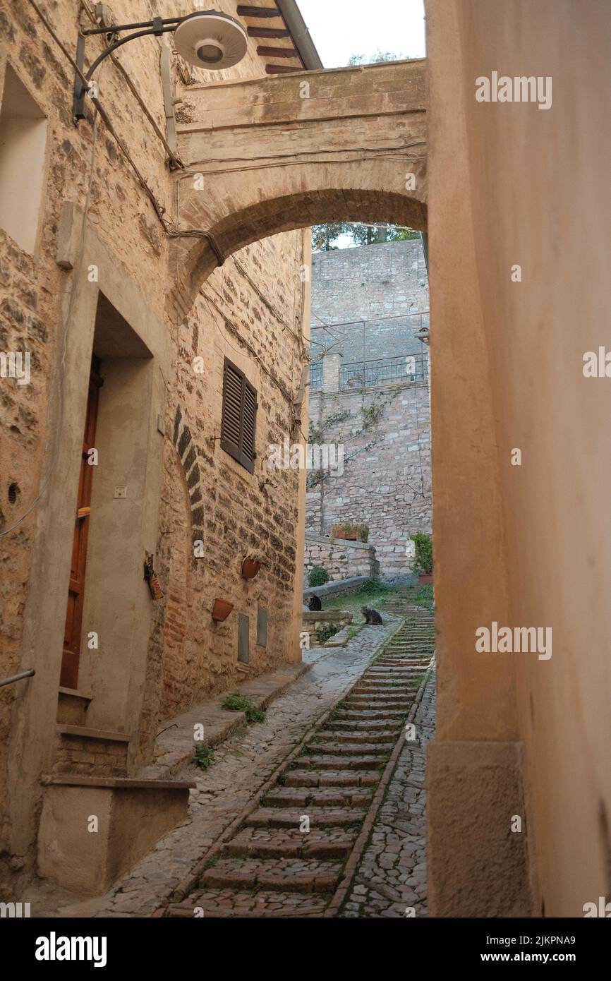 A vertical shot of the narrow street in Assisi. Italy. Stock Photo