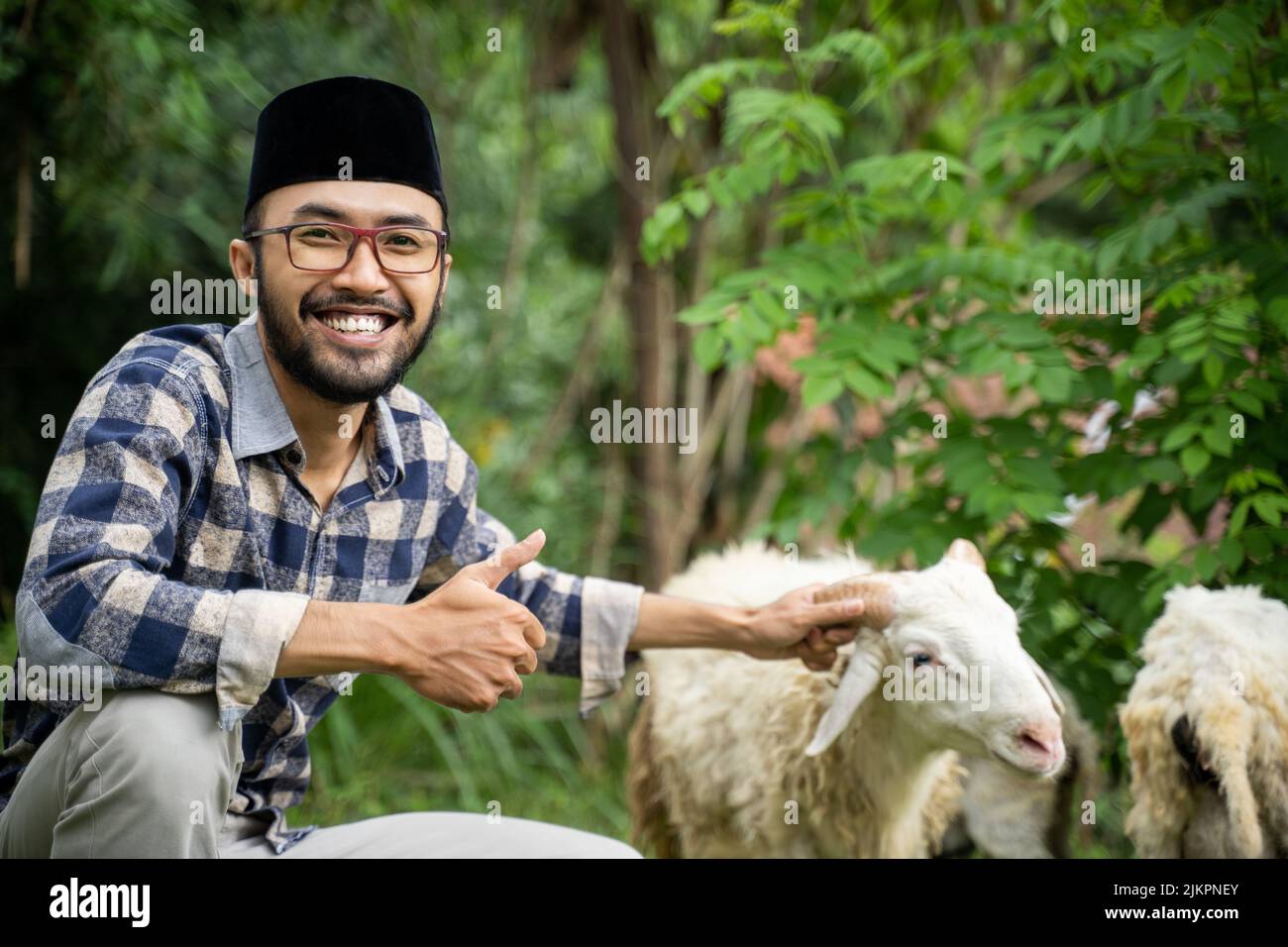 man farmer and seller of goat and cow checking his goat Stock Photo Alamy