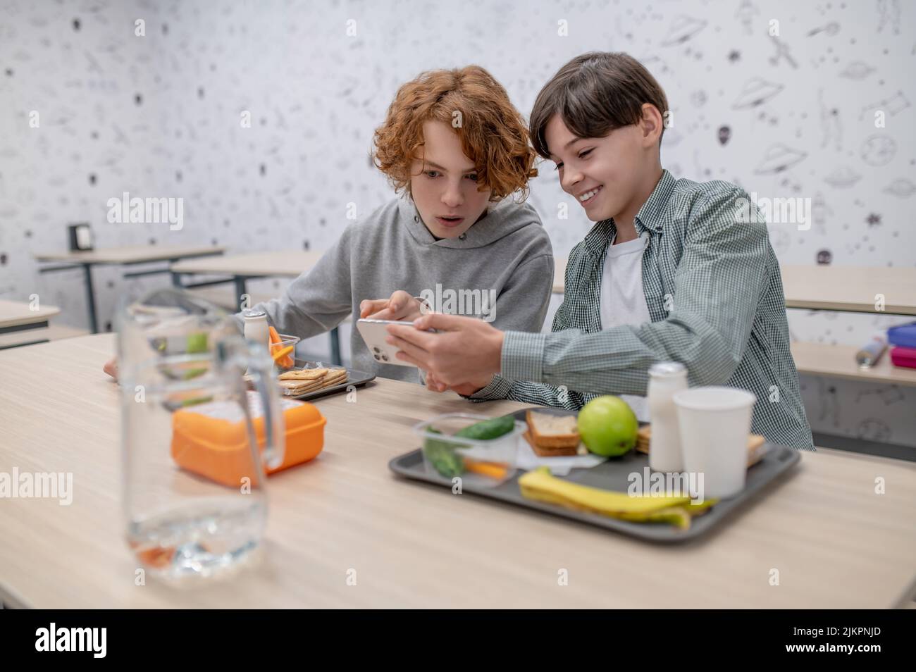 Two school boys having lunch in a school canteen Stock Photo