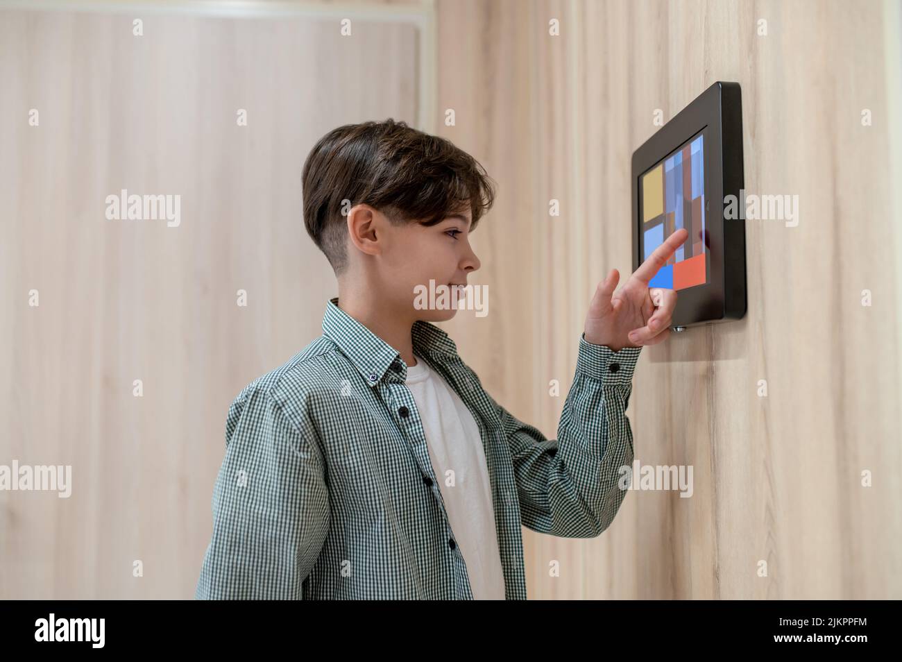 A boy touching screen of a sensor panel Stock Photo