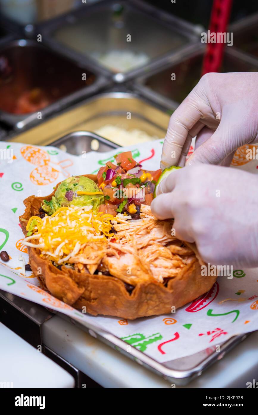 The process of making a Mexican chicken bowl with beans, guacamole and pico de gallo Stock Photo