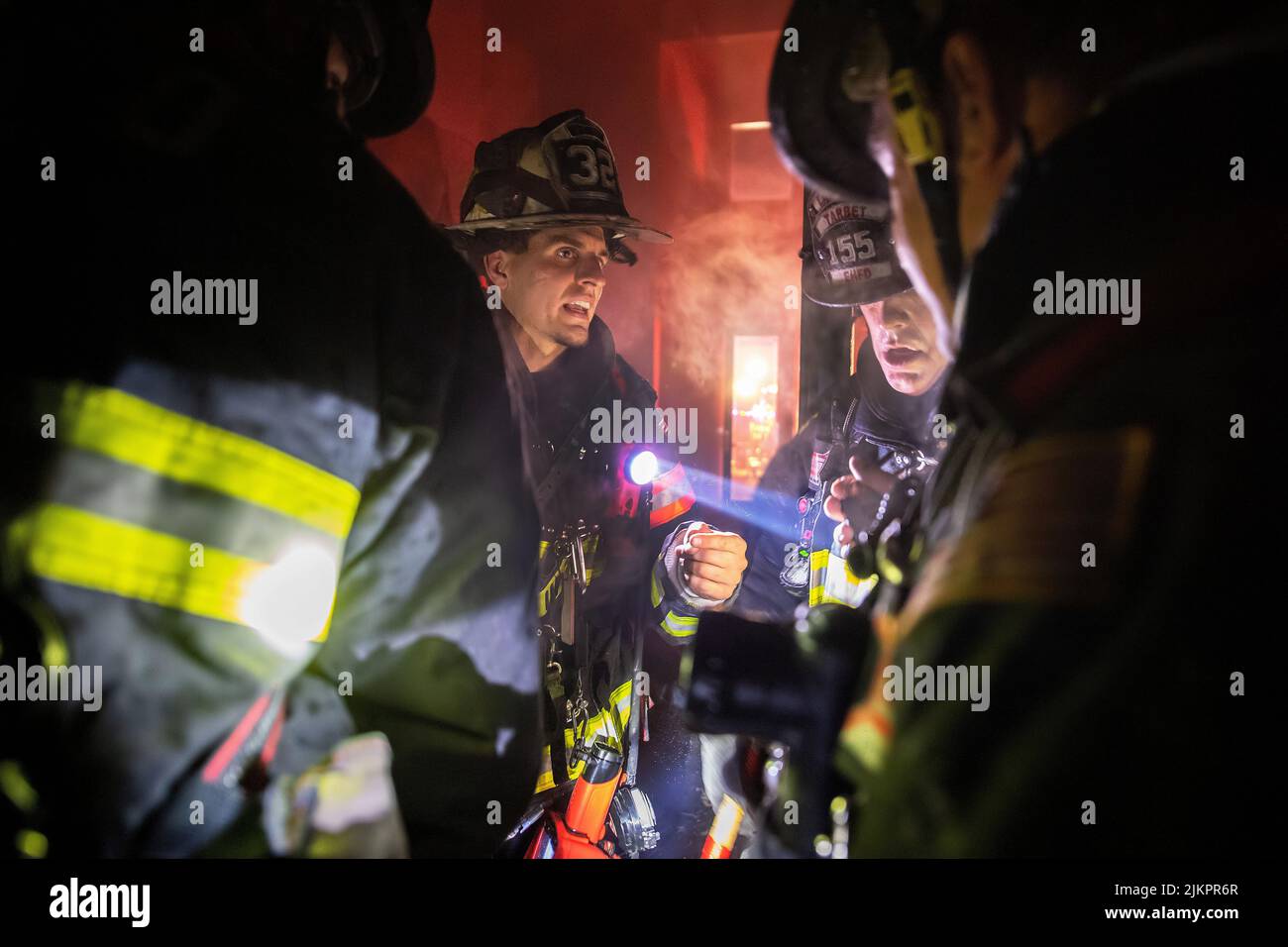 East Hampton Fire Department Assistant Chief Brian Stanis discusses strategies to attack the fire with his firefighters as at 12:08 a.m. on Monday mor Stock Photo