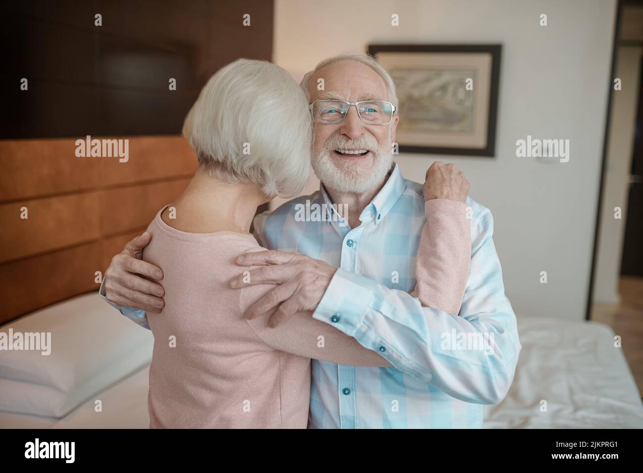 Senior man and woman hugging and looking in love Stock Photo