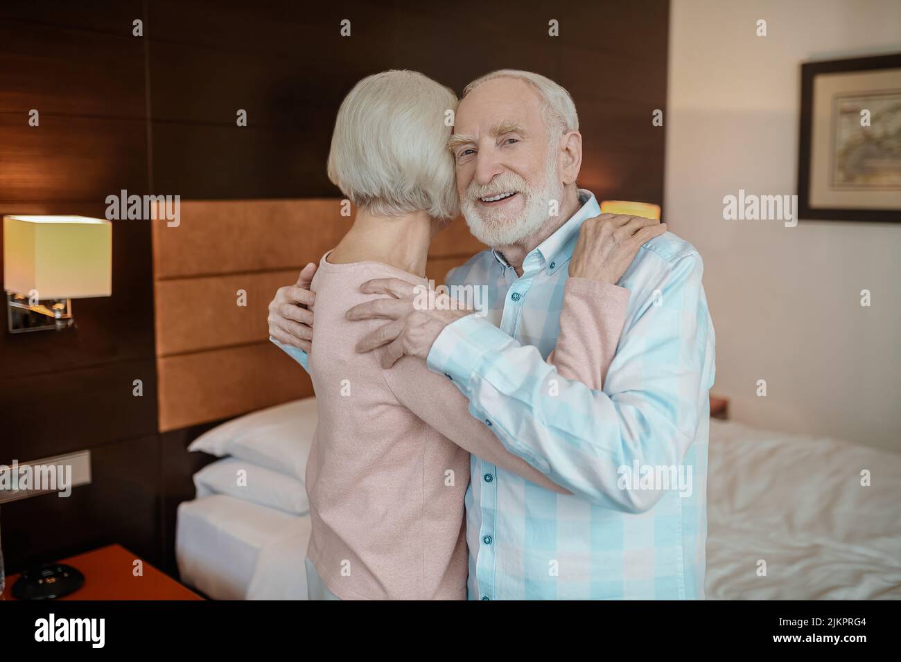 Senior man and woman hugging and looking in love Stock Photo