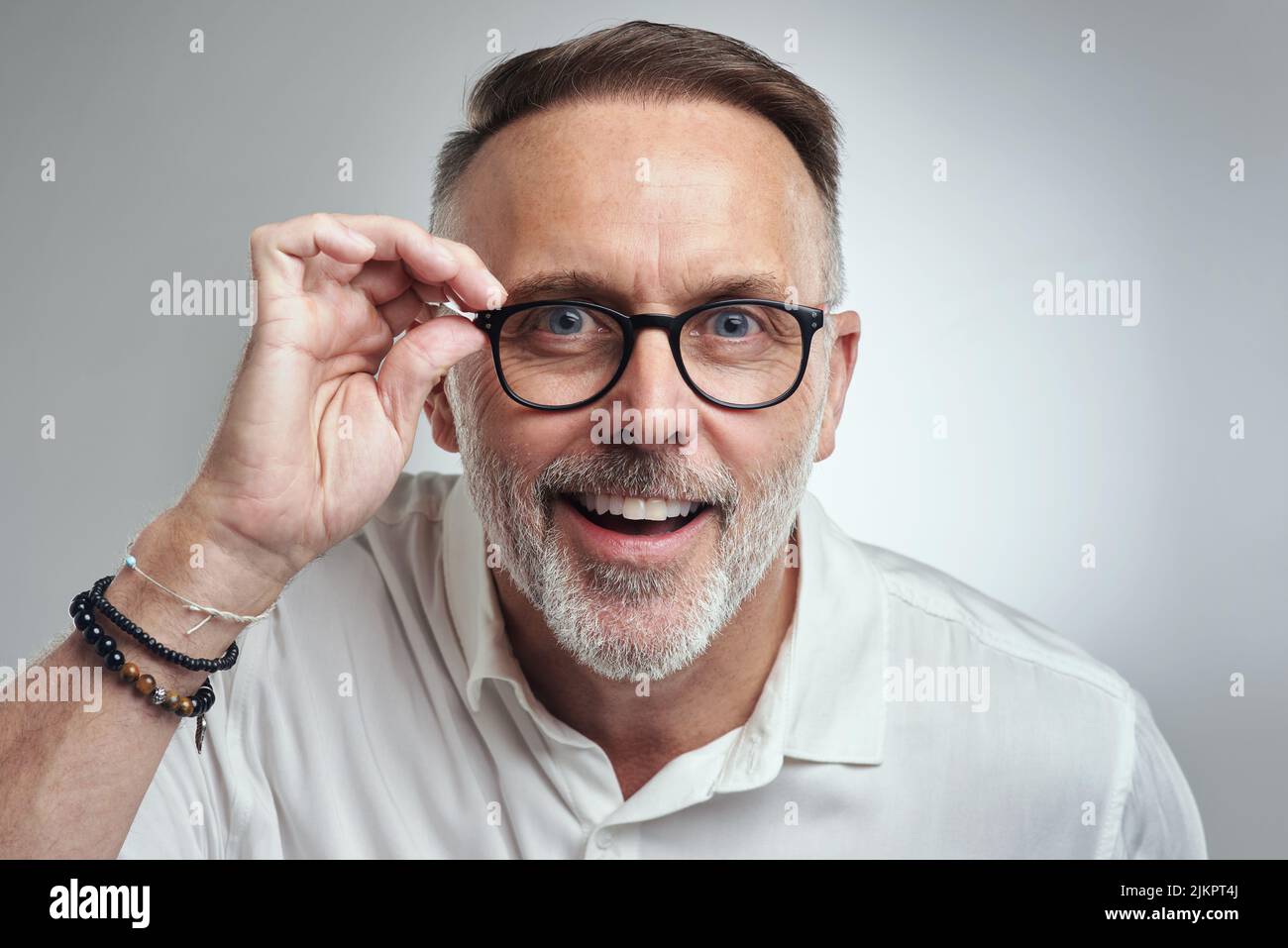 Seeing is believing. Studio portrait of a mature man wearing spectacles against a grey background. Stock Photo