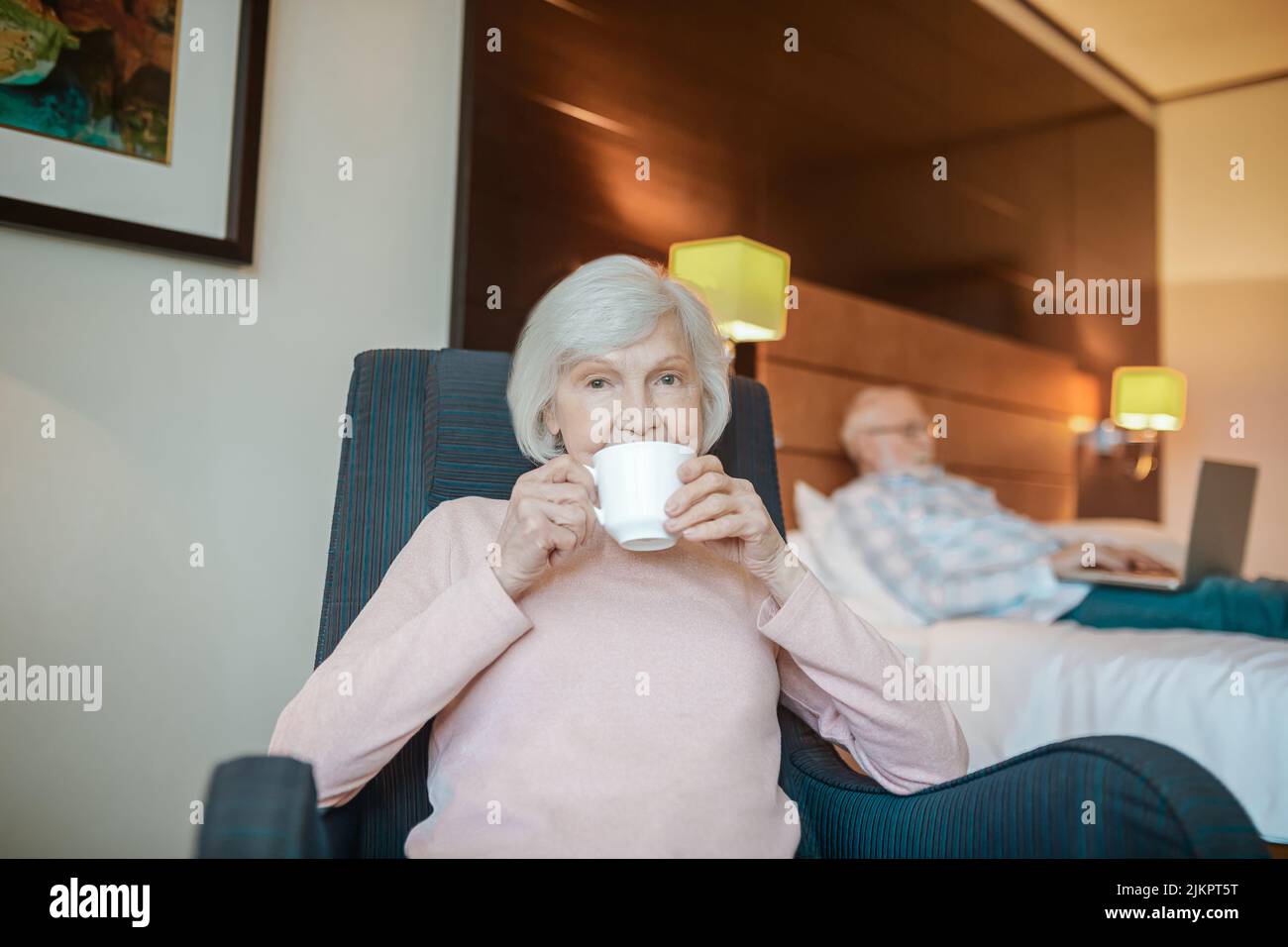 Pleasant-looking senior woman with a cup of coffee Stock Photo