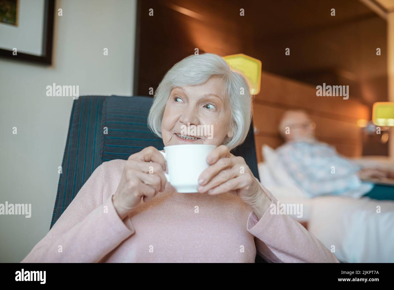 Pleasant-looking senior woman with a cup of coffee Stock Photo