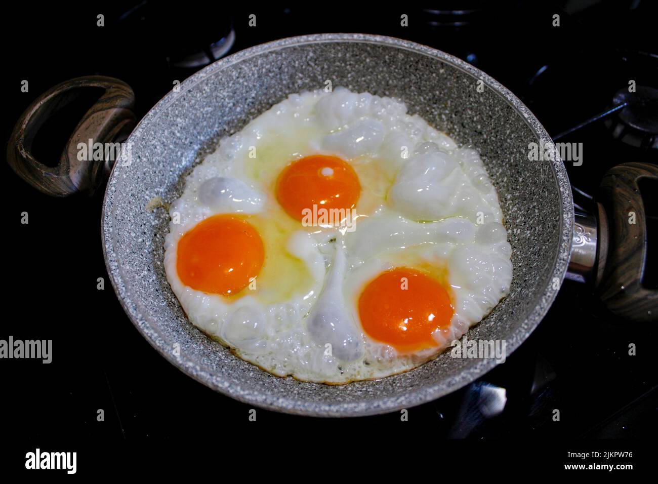 fried eggs in a frying pan, top view Stock Photo Alamy