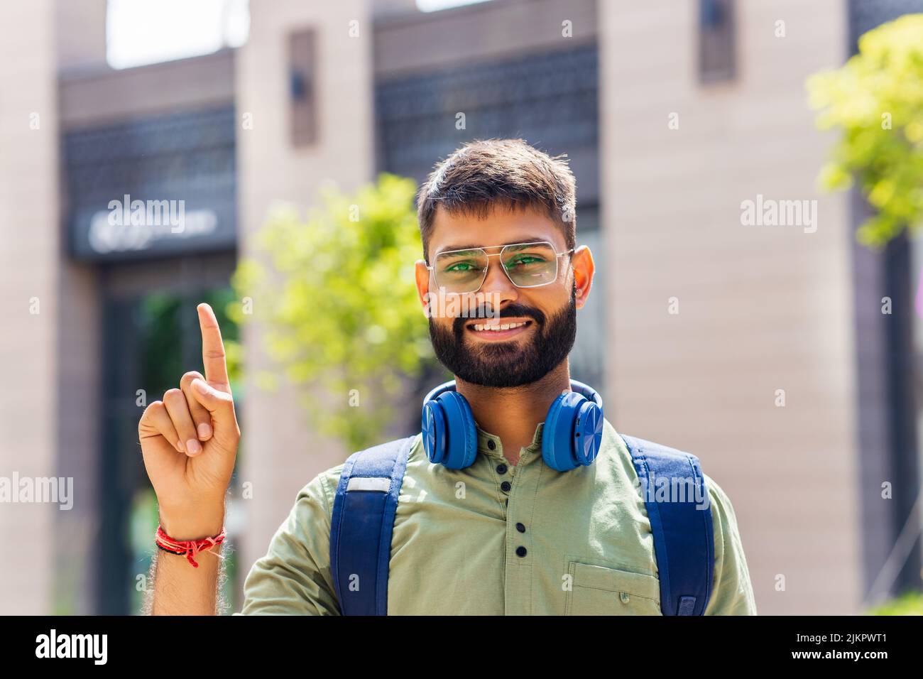 student looking happy and showing friendly gesture outdoors Stock Photo