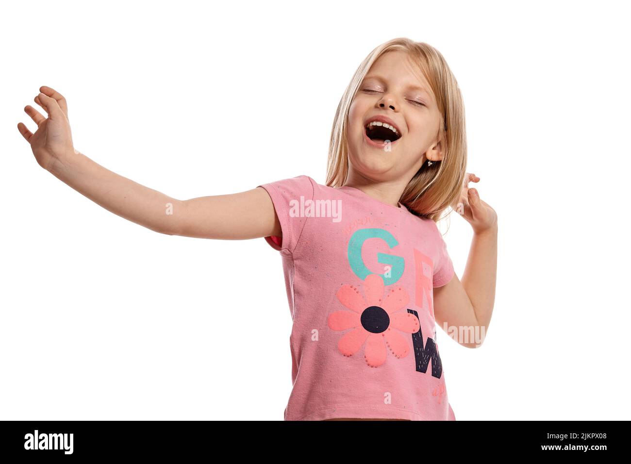 Close-up portrait of a nice blonde little kid in a pink t-shirt posing isolated on white background. Stock Photo