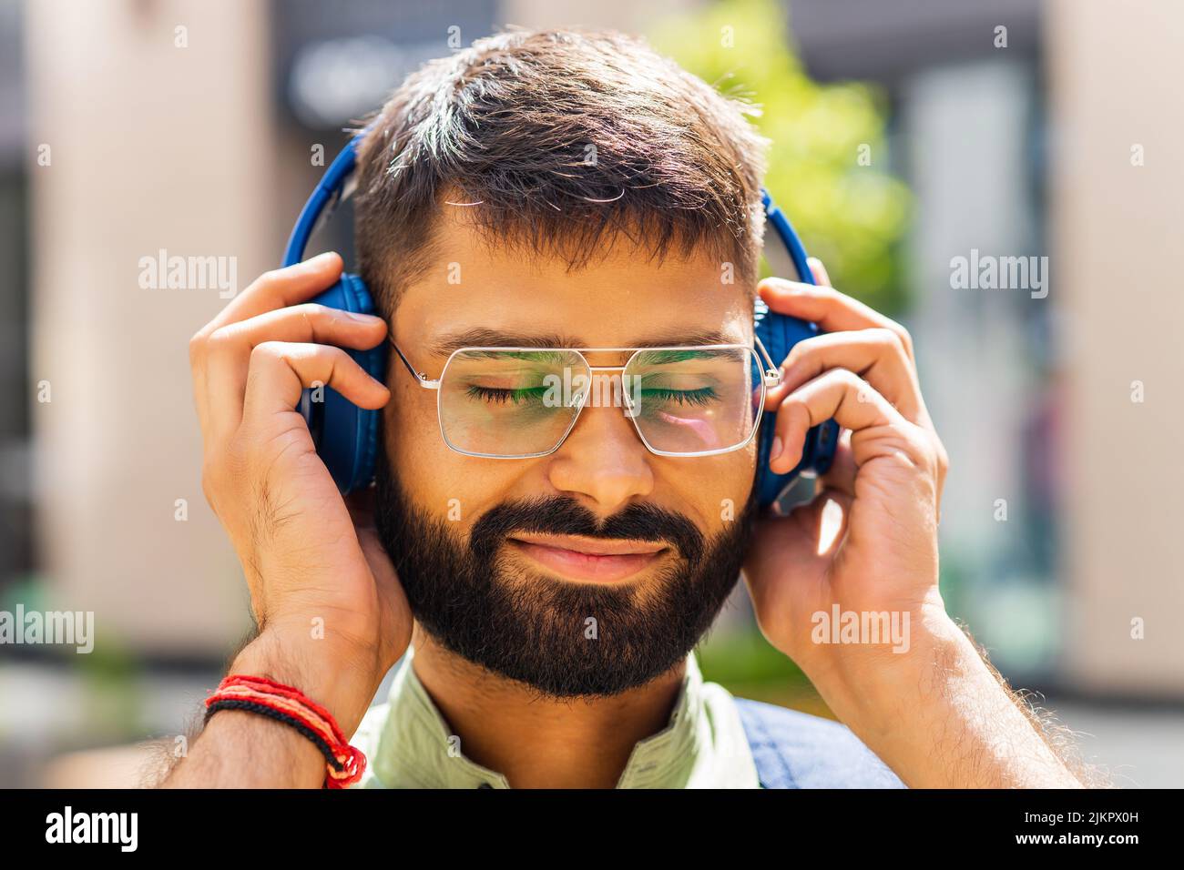 happy latin man listening to music headphones at the city Stock Photo