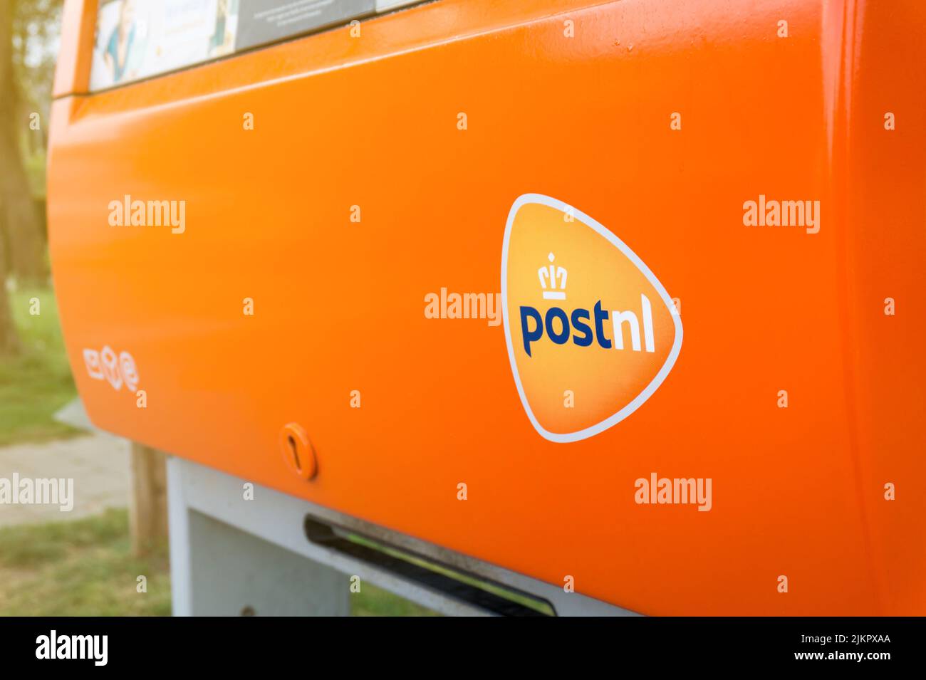 PostNL orange mail box with logo close-up. Dutch postal service company mailbox. Hertogenbosch, the Netherlands - May 7, 2022. Stock Photo