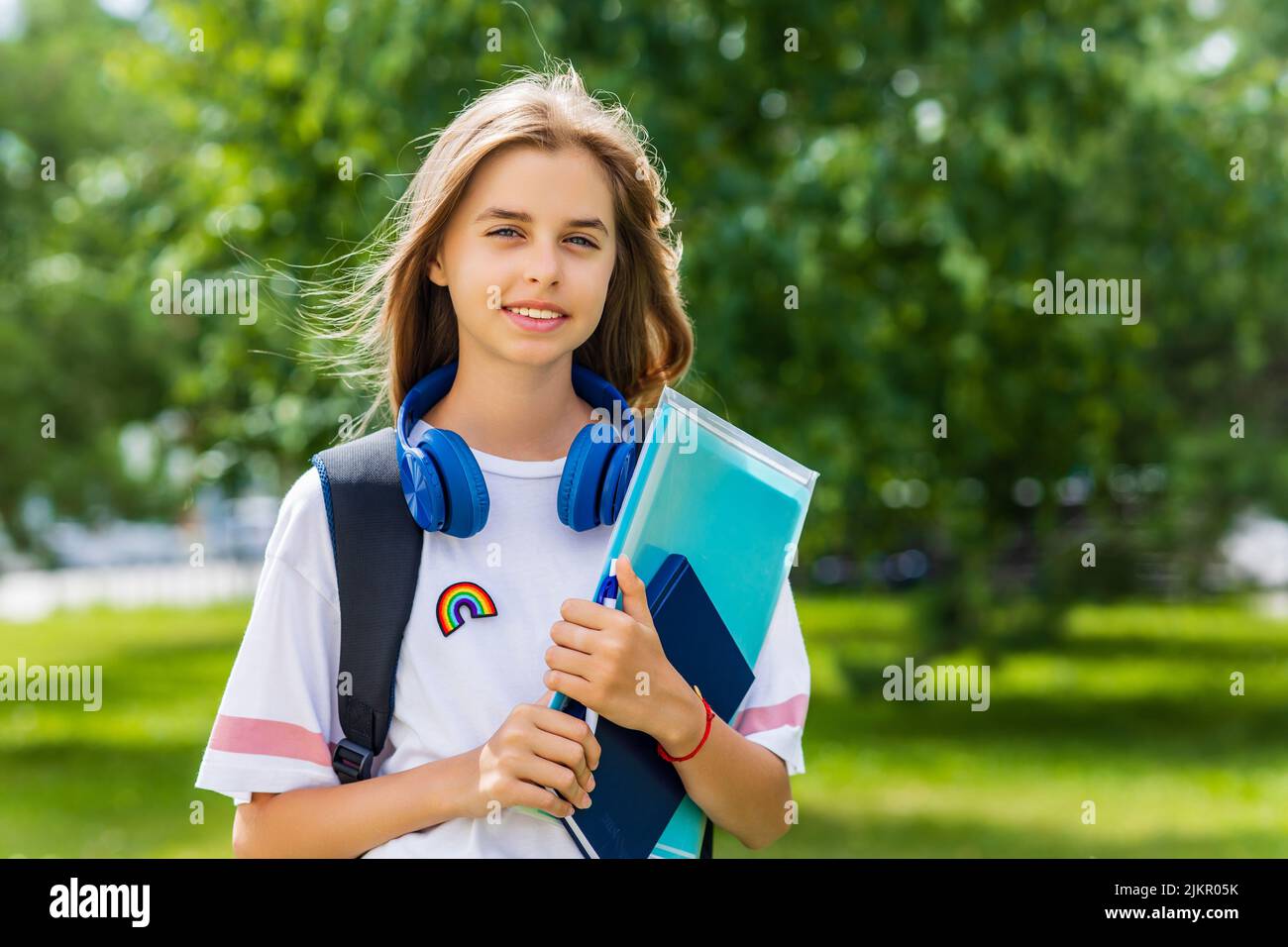 girl in white t-shirt with backpack going to school Stock Photo