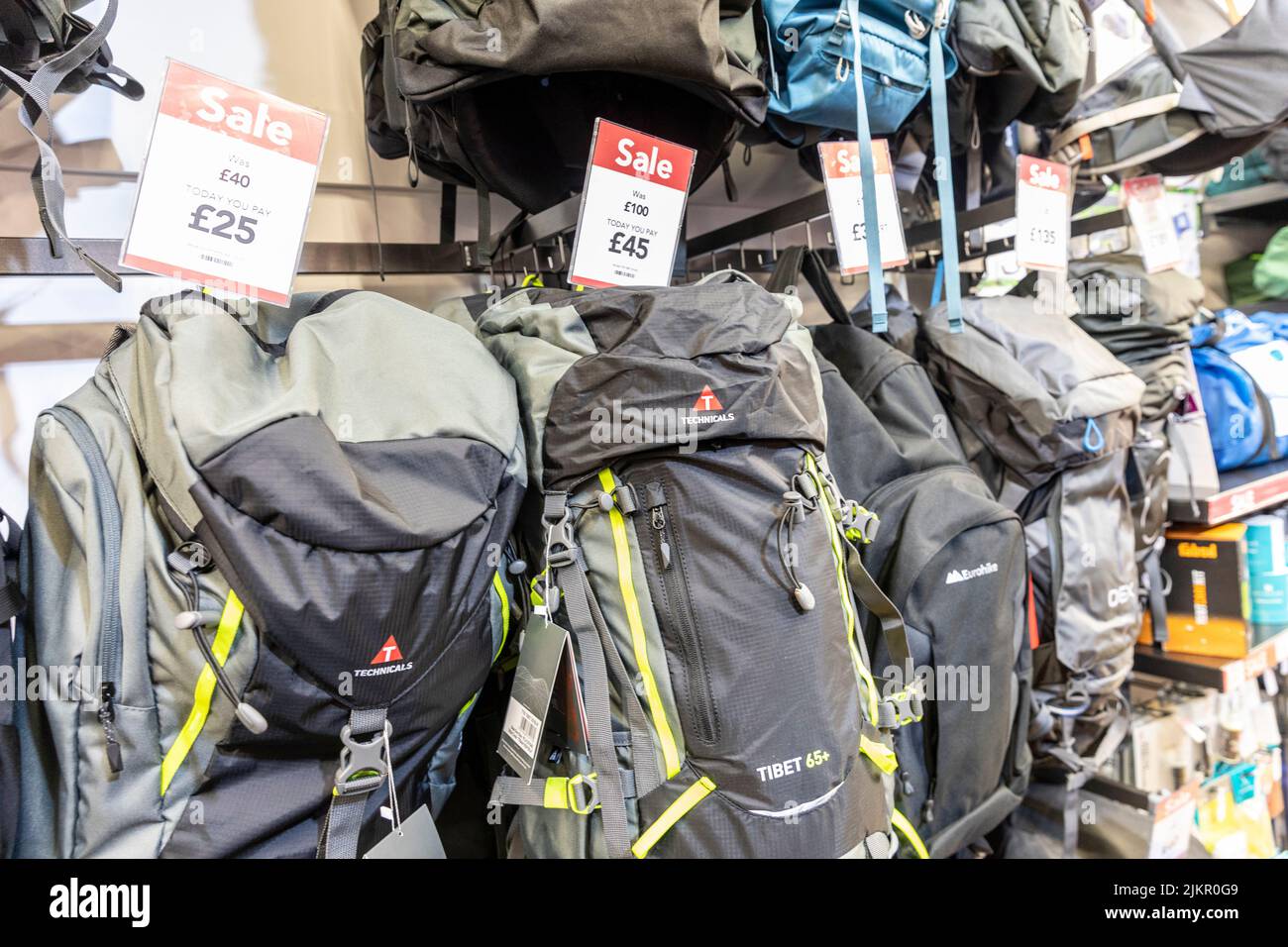 Rucksacks and backpacks on sale prices in a Millets store in Bury, July 2022 summer sale on outdoor clothing and accessories,Lancashire,England,Uk Stock Photo