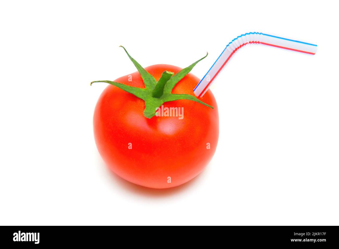 Ripe cocktail tomato with a drinking straw isolated on white background. Organic tomato juice concept. Stock Photo