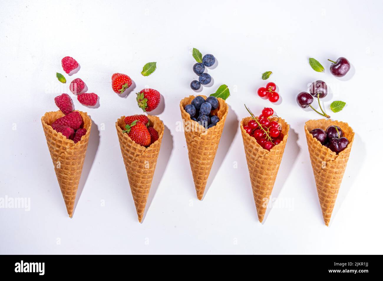 Waffle cones with fresh summer berries. Berry gelato, ice cream concept