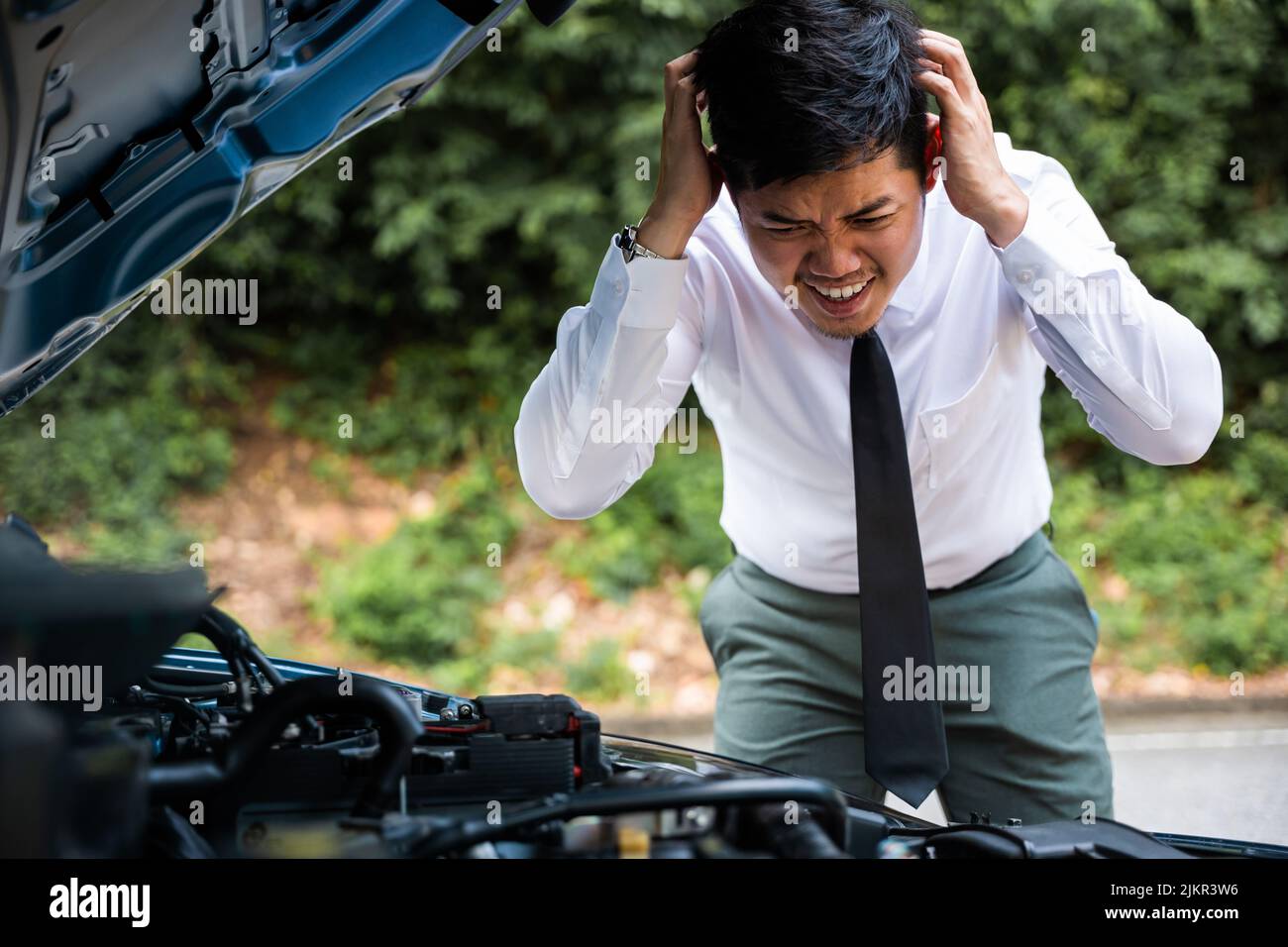 Asian businessman car broken breakdown, young stressed man having