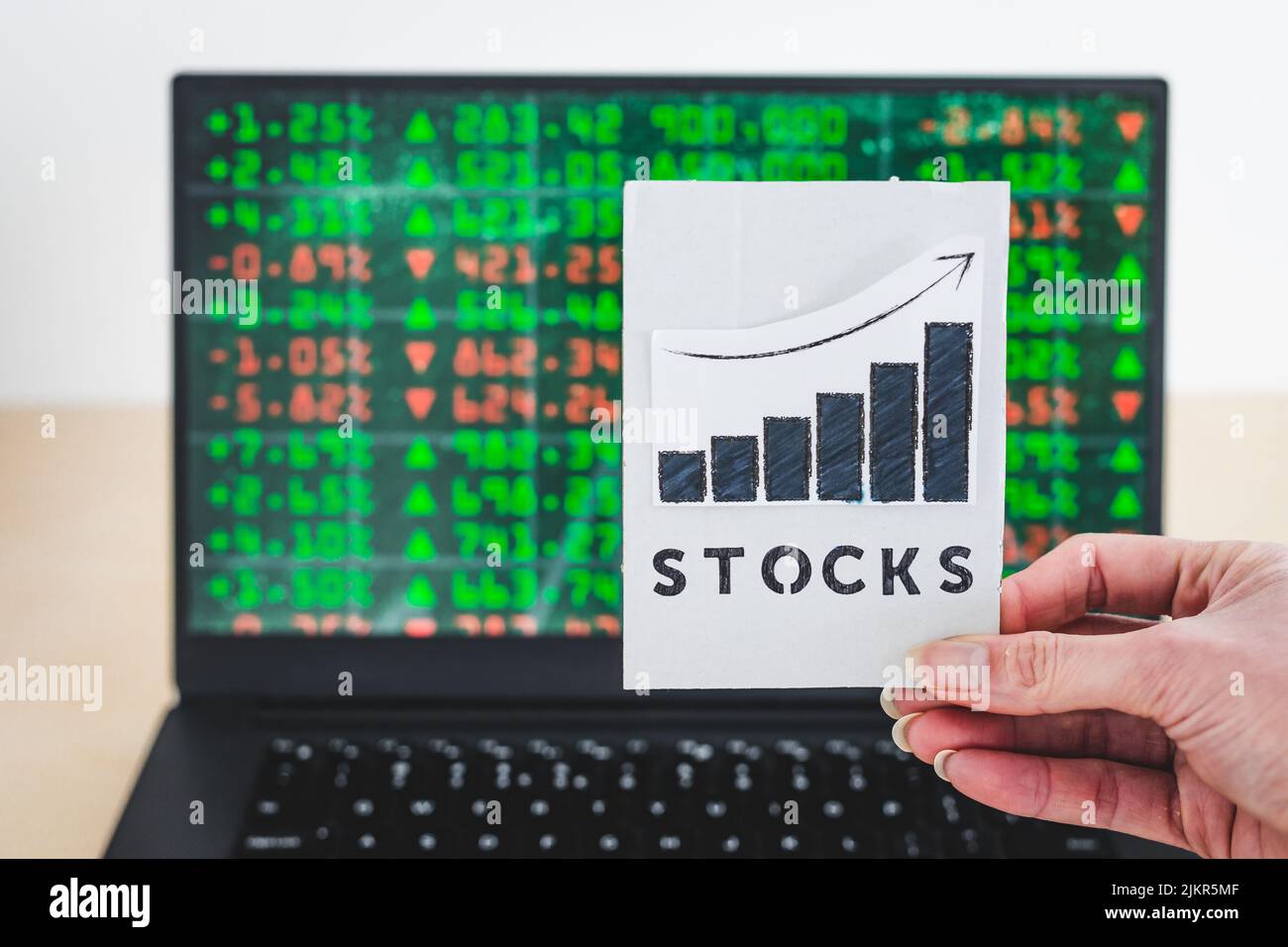concept of trading stocks online, chart with Stock text in front of computer screen with