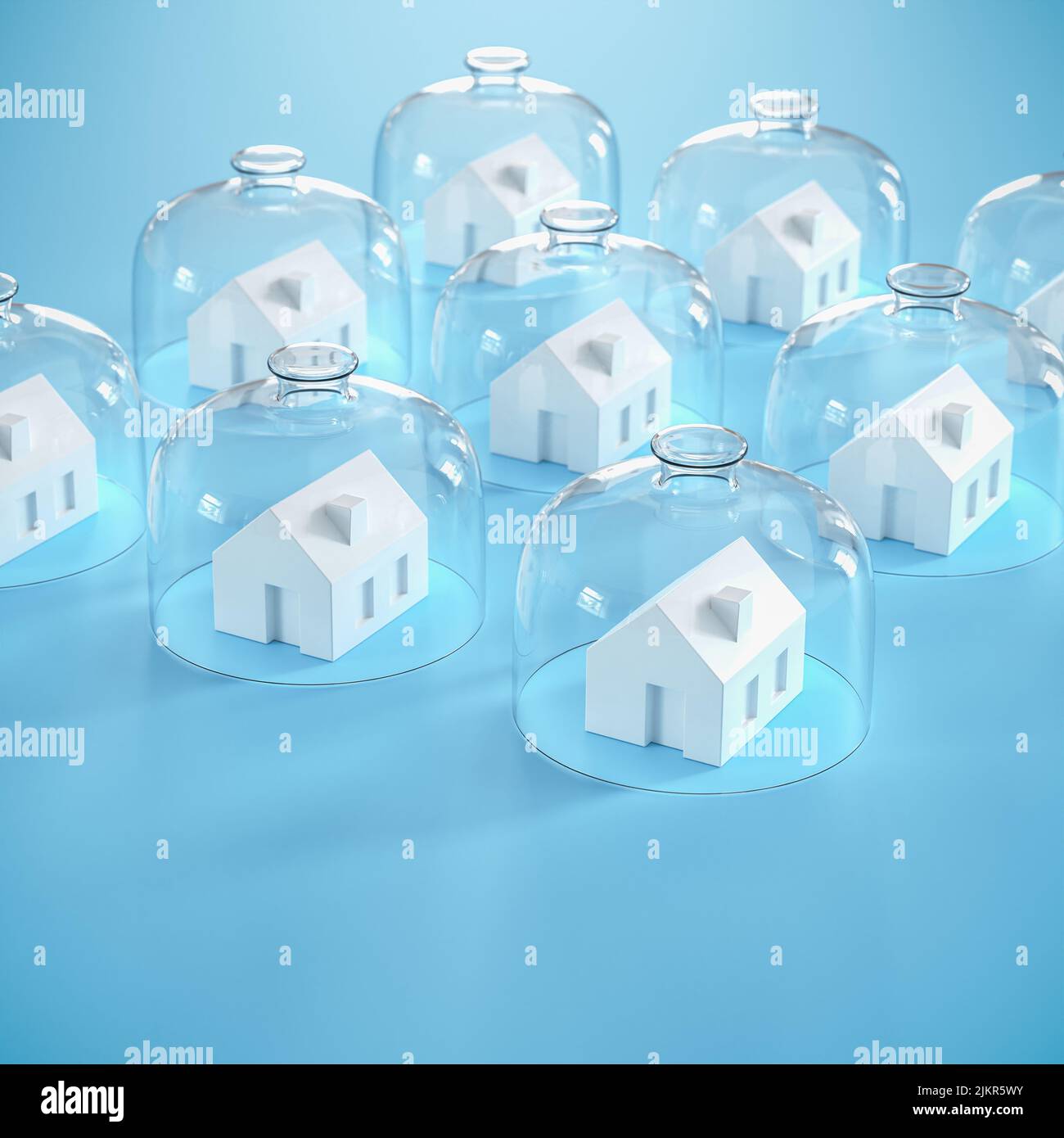 Proptecting your property concept - insurance, surveillance. Several model houses with glass domes. Stock Photo