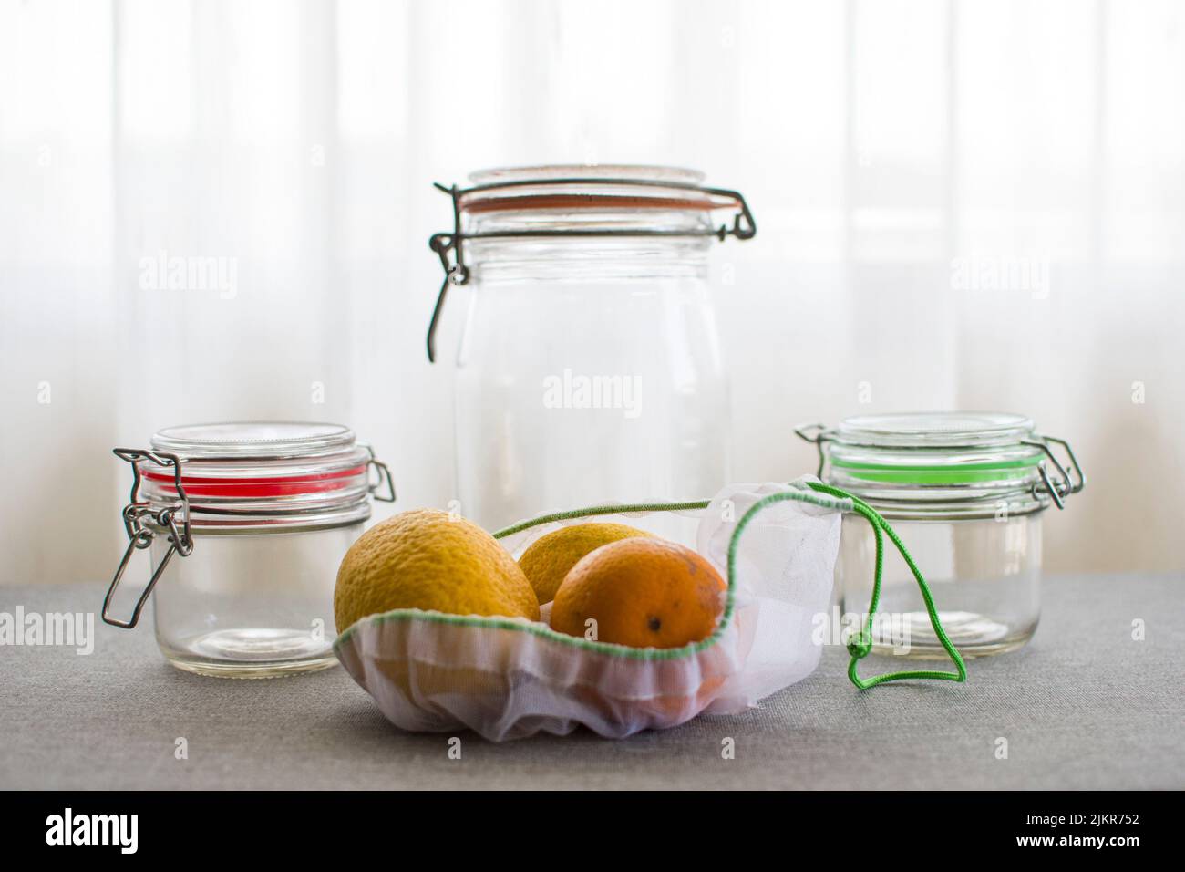 Glass jars and reusable bags for sustainable storage and shopping Stock Photo