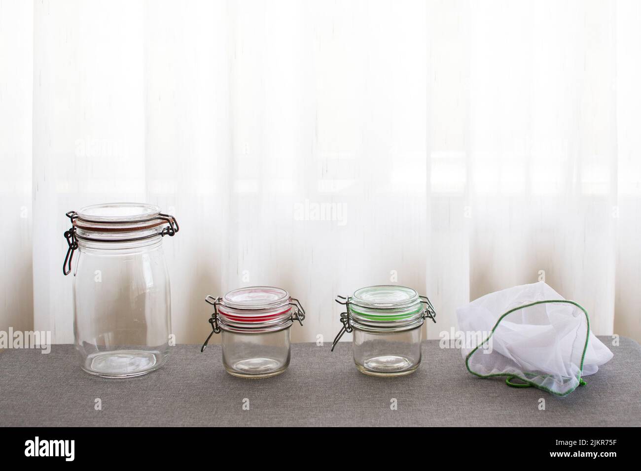 Glass jars and reusable bags for sustainable storage and shopping Stock Photo
