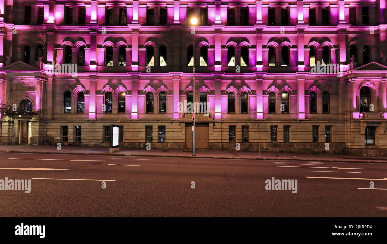 109 Pink-lit nightly façade of the ancient Treasury heritage building. Brisbane-Australia. Stock Photo